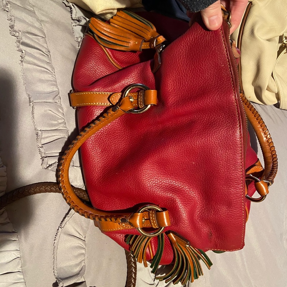 A red leather and green felt Dooney & Burke